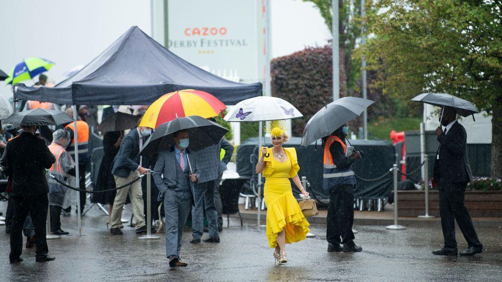 Racegoers arrive in the rain on Oaks day last year