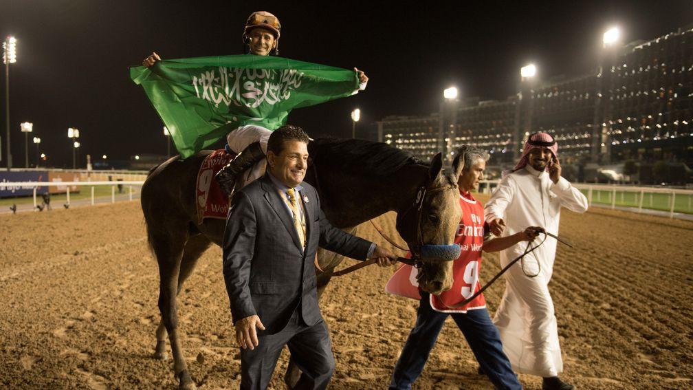 The Saudi Arabian flag is waved by Mike Smith after his win on the Khalid Abdullah-owned Arrogate in the 2017 Dubai World Cup