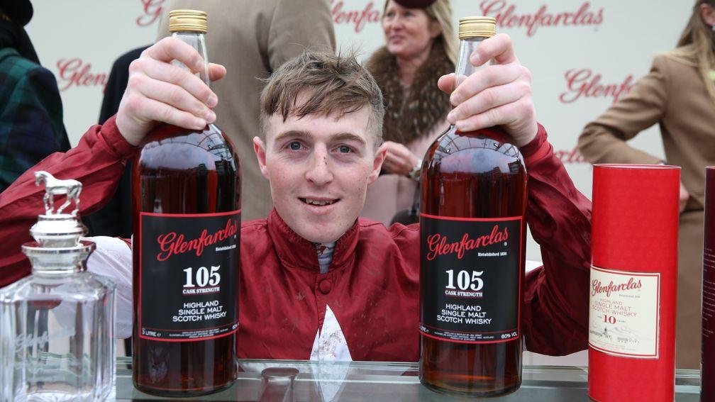Jockey Keith Donoghue poses after Tiger Roll's victory in the Glenfarclas Chase