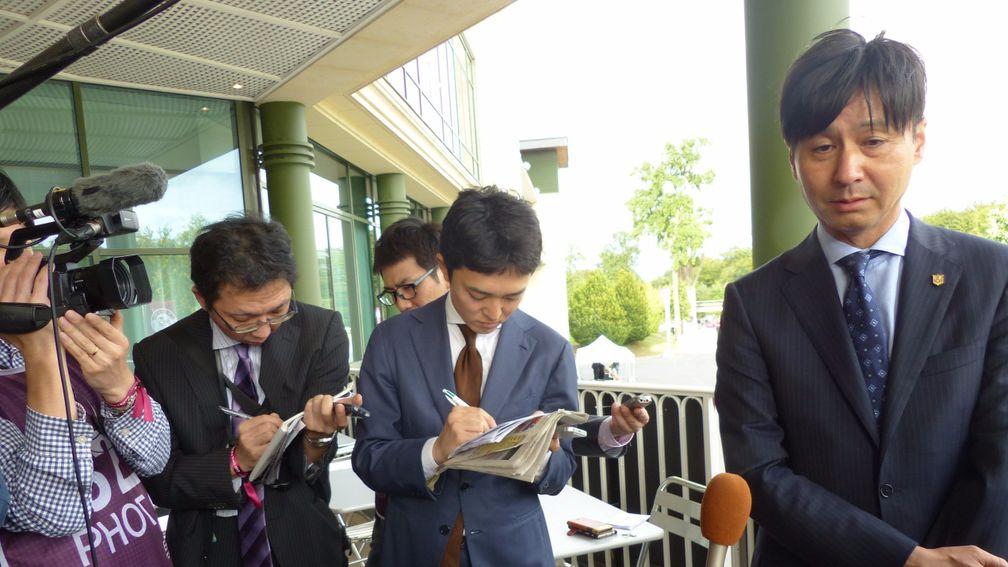 Yasutoshi Ikee answers questions from the travelling Japanese racing media after Satono Diamond's defeat in the Prix Foy