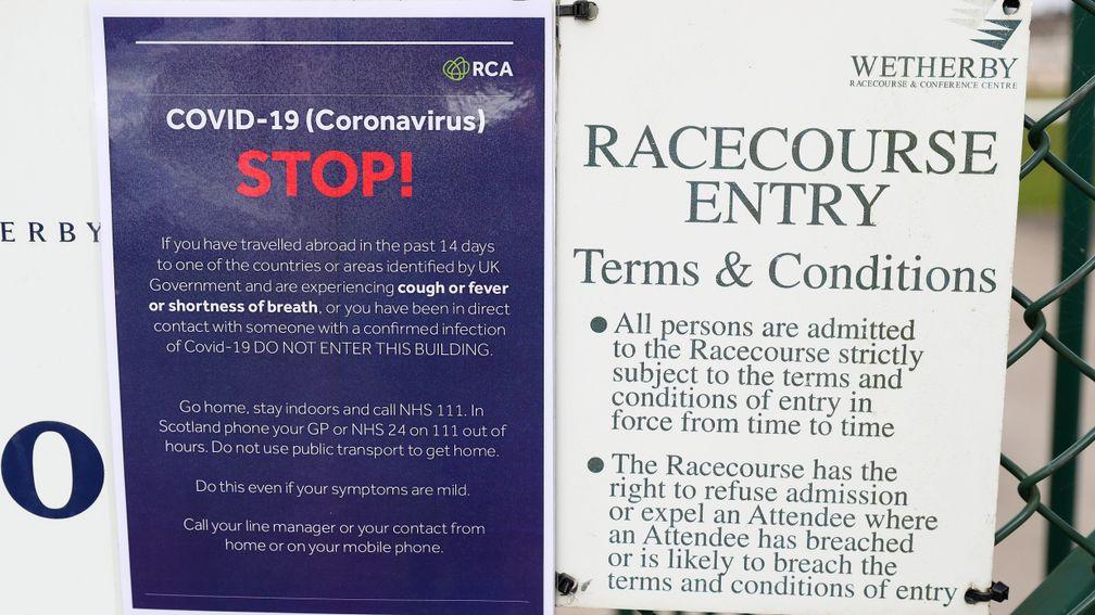 WETHERBY, ENGLAND - MARCH 17: A Covid-19 sign is seen outside Wetherby Racecourse ahead of Wetherby Races on March 17, 2020 in Wetherby, England. (Photo by Alex Livesey/Getty Images)