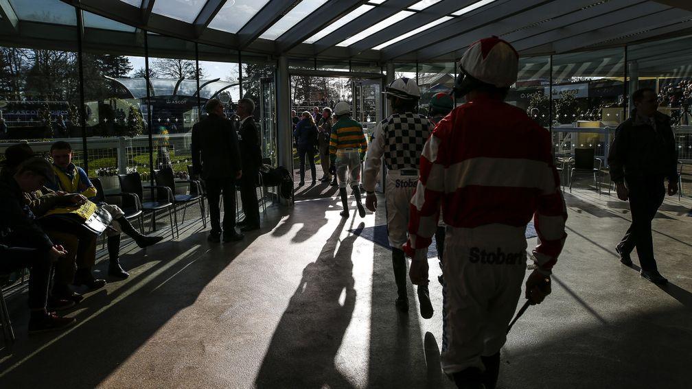 ASCOT, ENGLAND - FEBRUARY 17:  Jockeys make their way to the parade ring at Ascot Racecourse on February 17, 2018 in Ascot, England. (Photo by Alan Crowhurst/Getty Images)