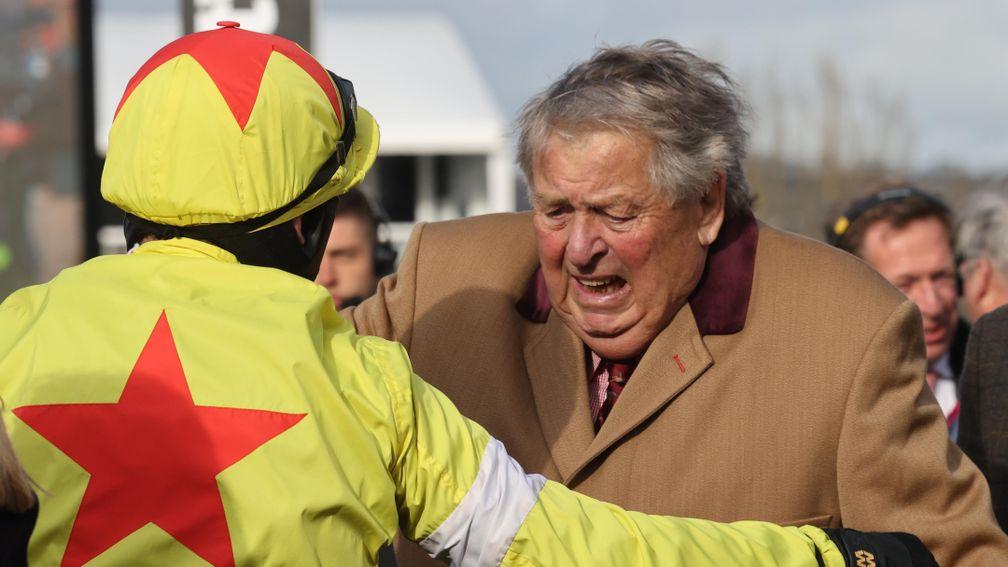 Politologue's owner John Hales is overcome with emotion as he embraces winning jockey Harry Skelton after the Champion Chase