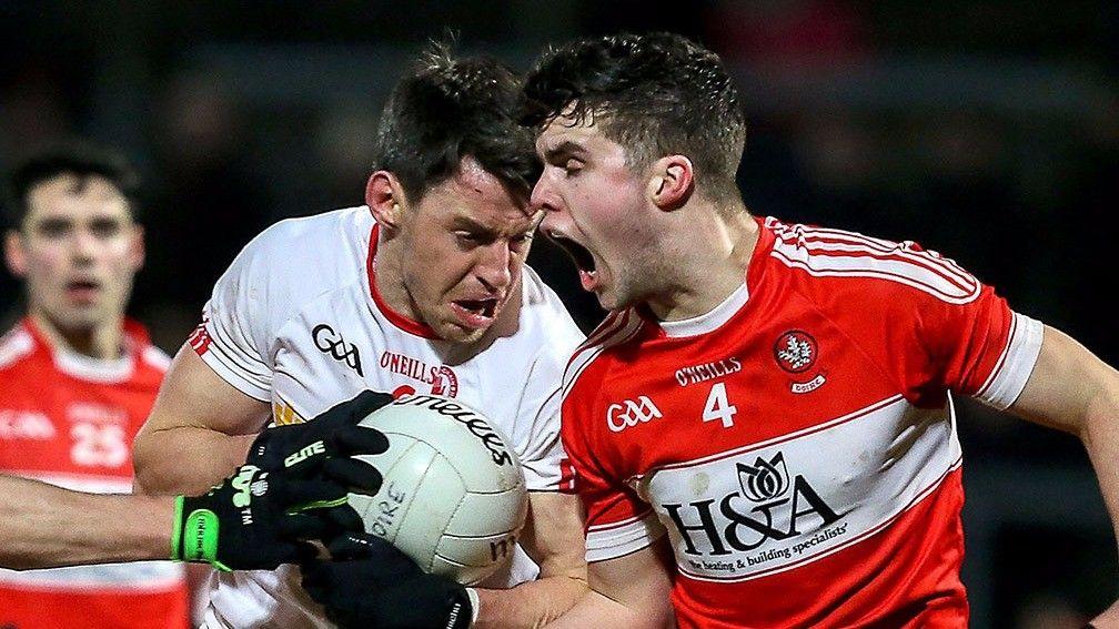 Tyrone’s Mattie Donnelly (left) shields the ball against Derry’s Neil Forester in the McKenna Cup final