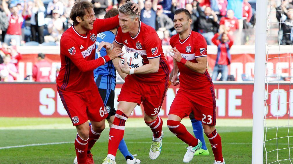 Bastian Schweinsteiger celebrates scoring for Chicago Fire with Joao Meira (66) and Nemanja Nikolic