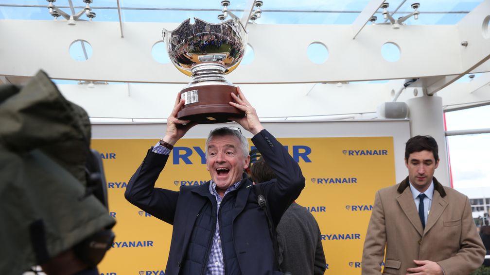 A delighted Michael O'Leary holding aloft his own trophy