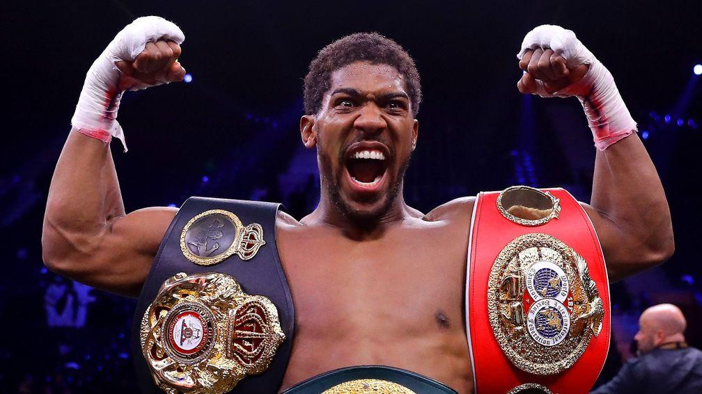 Anthony Joshua poses with the World Heavyweight Title belts beating Andy Ruiz