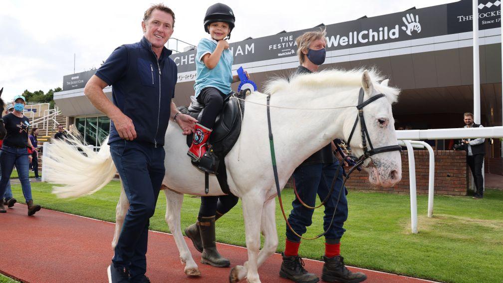 Sir Anthony McCoy pictured with Zaccy Nwachukwu, 4, at a WellChild charity day at Cheltenham racecourse