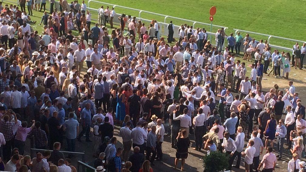Racegoers and football fans at Sandown on Saturday celebrate England's quater-final win over Sweden