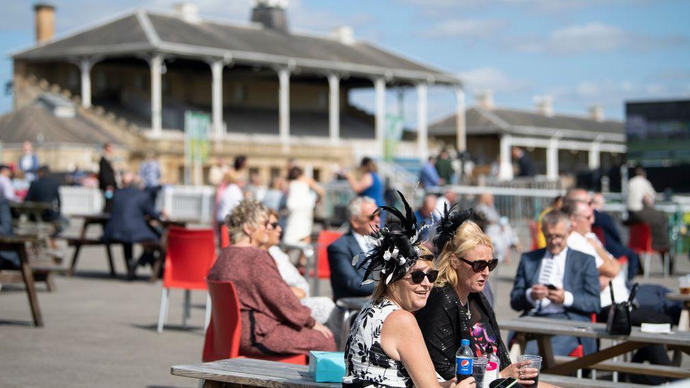 Rare sight: spectators enjoy the sunshine on day one of the St Leger meeting at Doncaster. Racegoers were stopped from attending the final three days of the fixture by public health officials