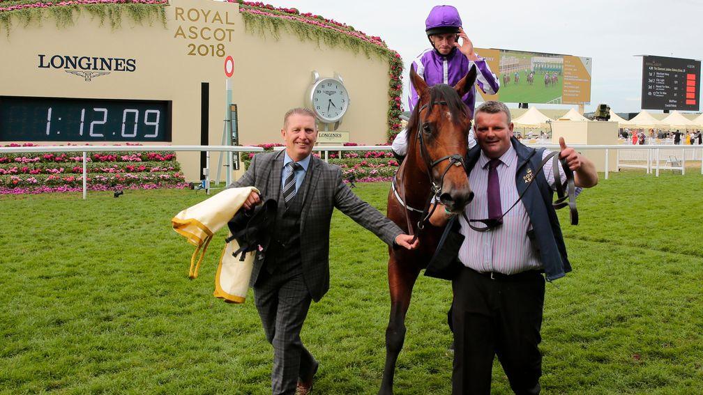 Job well done: groom David Hickey (right) gives a thumbs-up as he leads in Merchant Navy with Aidan O'Brien's travelling head lad Pat Keating at Royal Ascot
