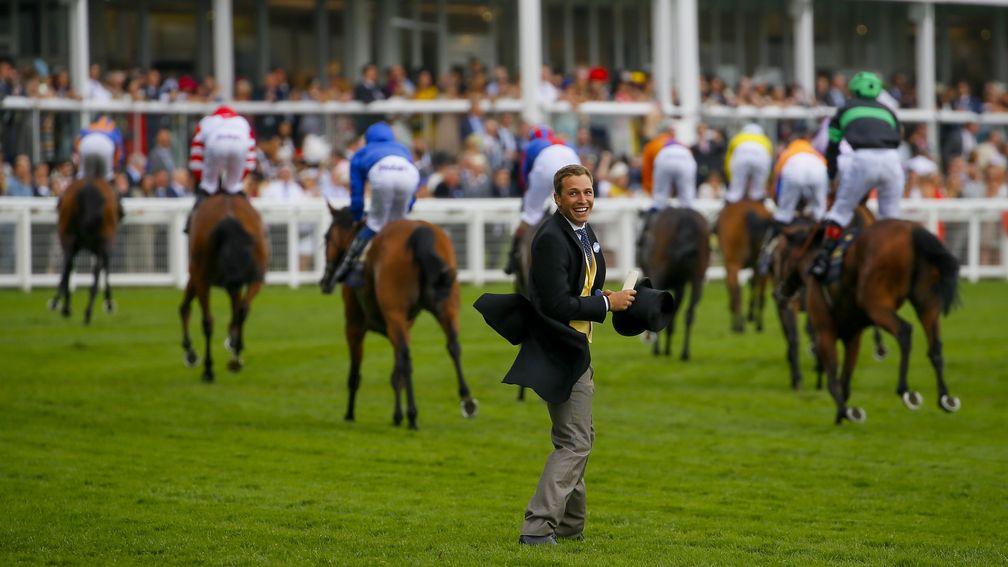 ITV's Oli Bell runs out on to the track at Ascot to greet Gold Cup winner Big Orange
