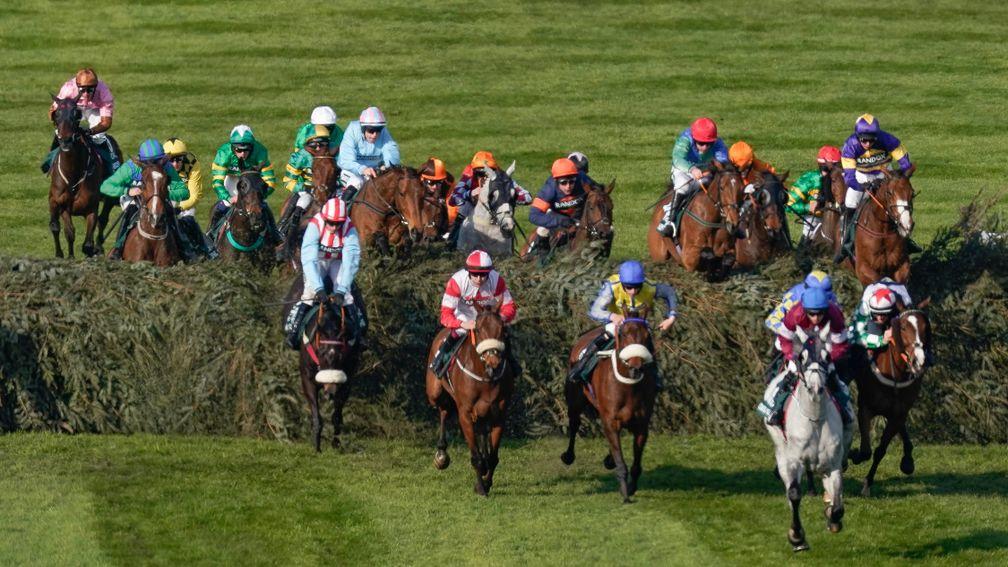 The Grand National field clear the Chair fence at Aintree yesterday