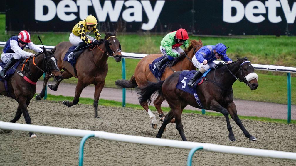LINGFIELD, ENGLAND - JANUARY 07: Kieran O'Neill riding Strong Power (blue) win The Betway Handicap at Lingfield Park Racecourse on January 07, 2022 in Lingfield, England. (Photo by Alan Crowhurst/Getty Images)