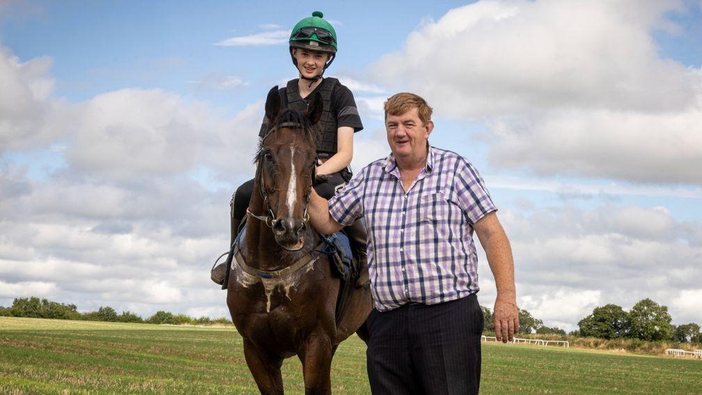 Shark Hanlon with son Paddy onboard stable star Hewick, who will look to conquer the Cheltenham Gold Cup and Aintree Grand National in the coming weeks