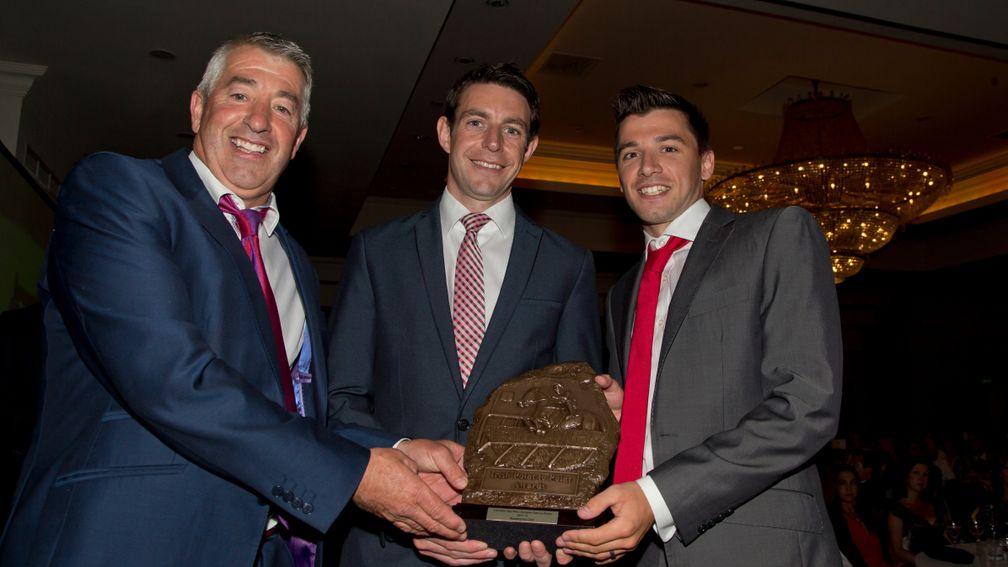 Michael McConville (right) and his father Stephen (left) accept the Red Mills champion point-to-pointer award for Anseanachai Cliste from John Gerety of Red Mills (centre) in 2016