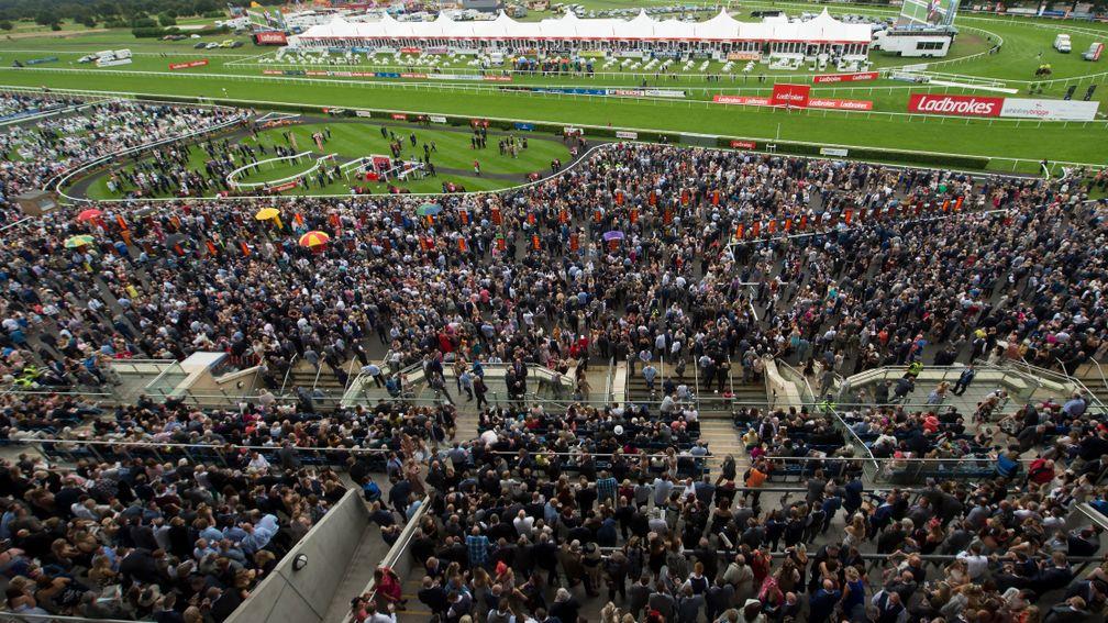 A huge crowd gathers as the runners for the Portland Handicap circle the parade ring at Doncaster in 2016
