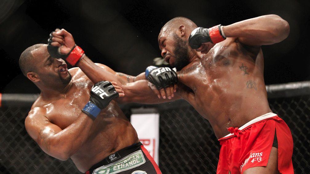 Jon Jones (right) punches Daniel Cormier at UFC 182