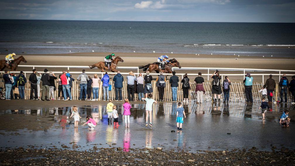 Kids playing in the puddles as Waqaas wins at Laytown