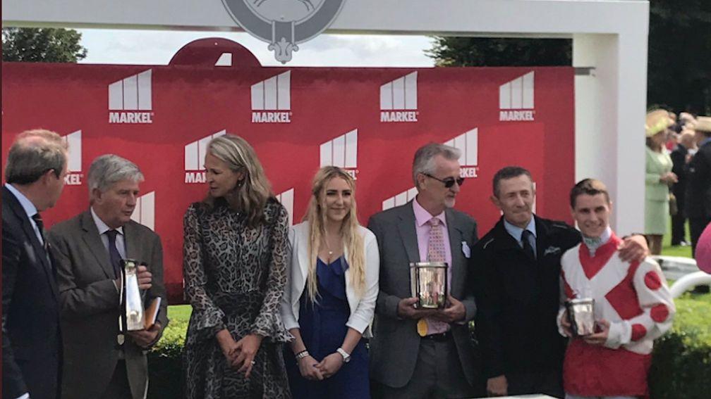 Philip Wilkins (third right) and the eponymous Liberty Beach (fourth right) receive the Molecomb trophy