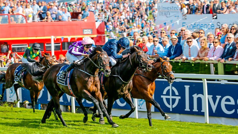 The crowd captivated by the 2017 Derby finish as Wings of Eagles (nearside) runs down stablemate Cliffs Of Moher and Frankie Dettori (red cap) on Cracksman