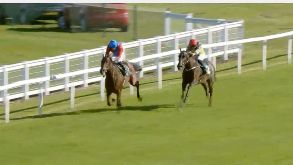 Doom (blue cap) looks set to oblige at slim odds having kicked ahead with a furlong and a half to go under Tom Marquand, with Pierre-Louis Jamin hard at work on Karmology