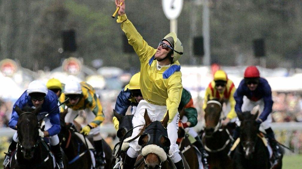 Damien Oliver points to the heavens after Media Puzzle's emotional 2002 Melbourne Cup victory