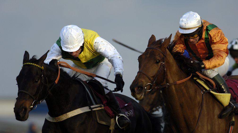 Trabolgan (Mick Fitzgerald, left) on the run in from the last to win the 2:40 Hennessy Cognac Gold Cup Chase (Handicap) (Class A) Grade 3 from L'Ami at Newbury racecourse. 26th November 2005