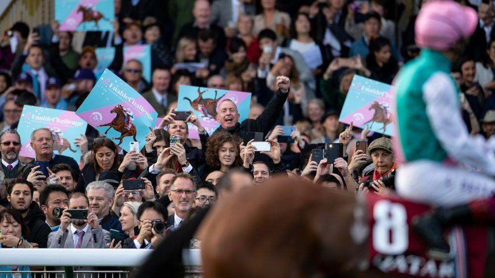 The Longchamp crowd cheers on Enable before the Arc