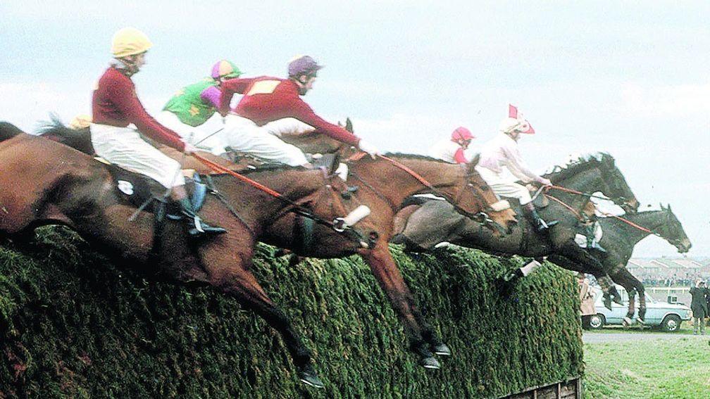 Tough guys: Red Rum and Brian Fletcher (nearest) clear an unmodified Becher's Brook on their way to winning the 1973 Grand National
