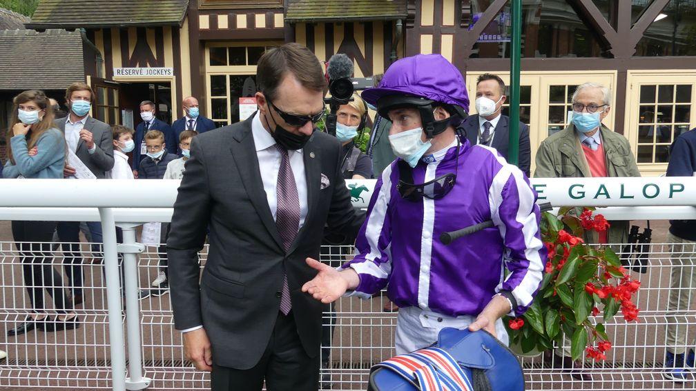 Aidan O'Brien gets a debrief from Ryan Moore after the Prix Rothschild