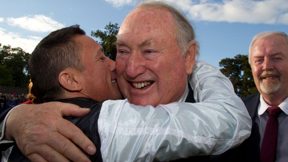 Frankie Dettori hugs Anthony Oppenheimer after winning the 2015 Irish Champion Stakes on Golden Horn
