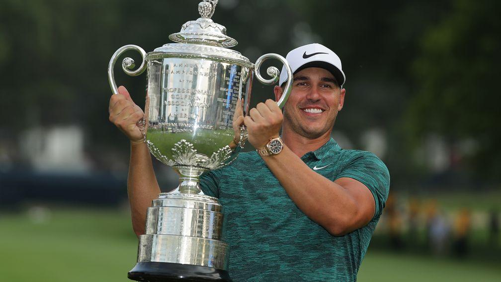 Brooks Koepka holds the Wanamaker Trophy aloft after victory at the 2018 US PGA Championship at Bellerive