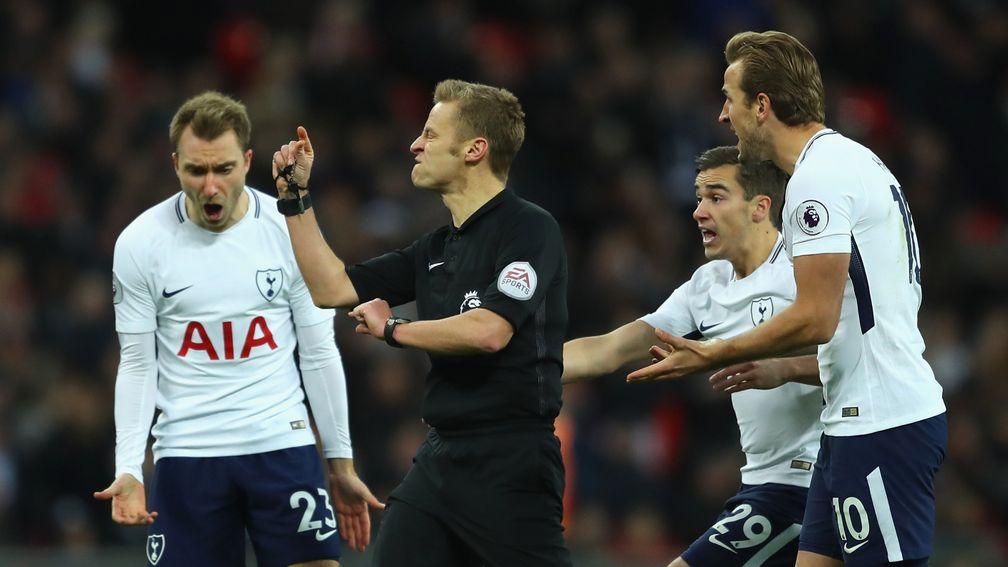 Christian Eriksen, Harry Winks and Harry Kane of Tottenham appeal to match referee Mike Jones during the Premier League match against West Brom