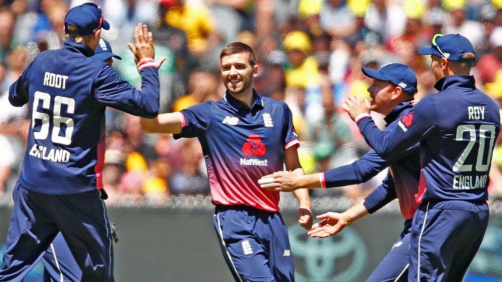 Mark Wood celebrates the early dismissal of Australia's David Warner in the first ODI