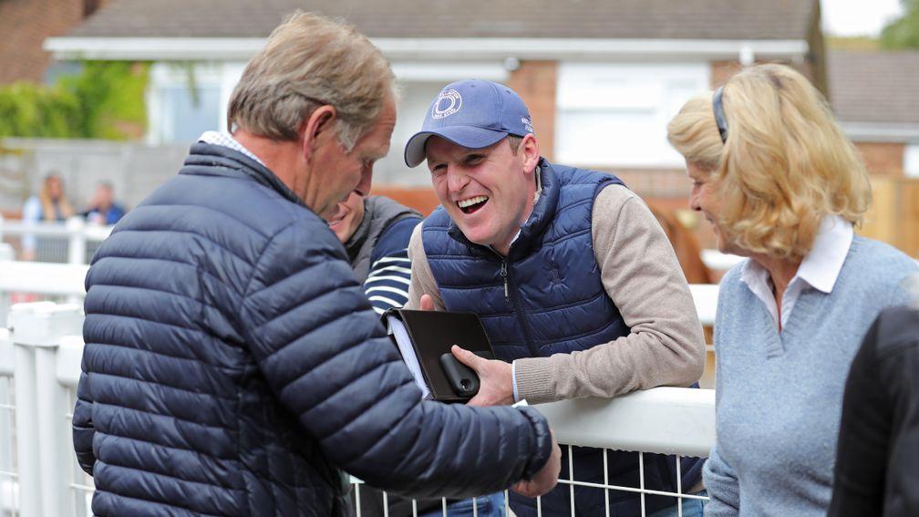 Michael Bell signs the docket as Billy Jackson-Stops and Sara Cumani look on