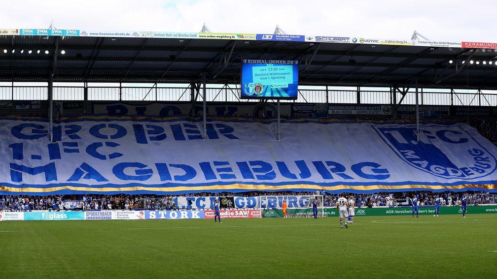 Supporters of Magdeburg showing a banner at MDCC-Arena