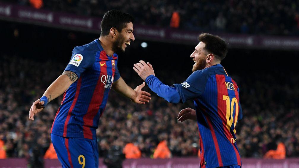 Barcelona's Lionel Messi celebrates with Luis Suarez