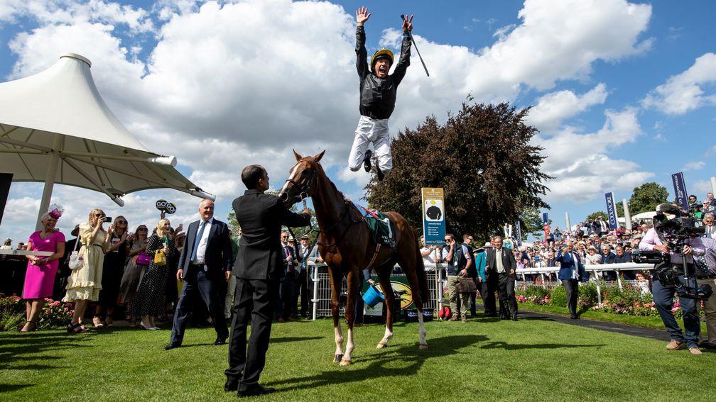 Frankie Dettori performs a flying dismount after Stradivarius' victory in the Lonsdale Cup