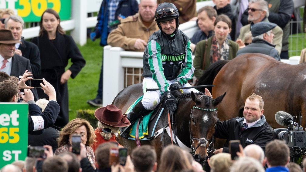 Altior and Nico de Boinville return to the winner's enclosure after winning the Celebration Chase at Sandown