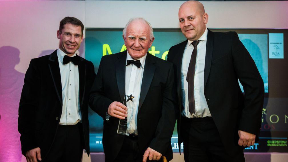 Milton Bradley is presented with a lifetime achievement award by former champion jockey Richard Johnson at the 2019 ROA Wales Horse Racing Awards