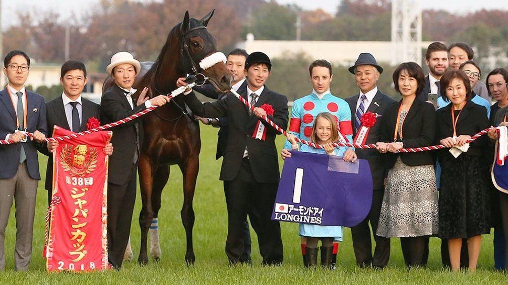 Jockey Christophe Lemaire stands next to trainer Sakae Kunieda (grey hat) at the official victory ceremony following Almond Eye's Japan Cup victory in November 2018