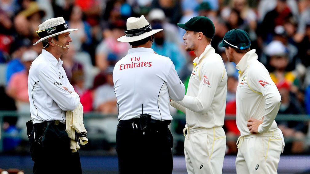 The umpires confront Australia's Cameron Bancroft and Steven Smith in Cape Town