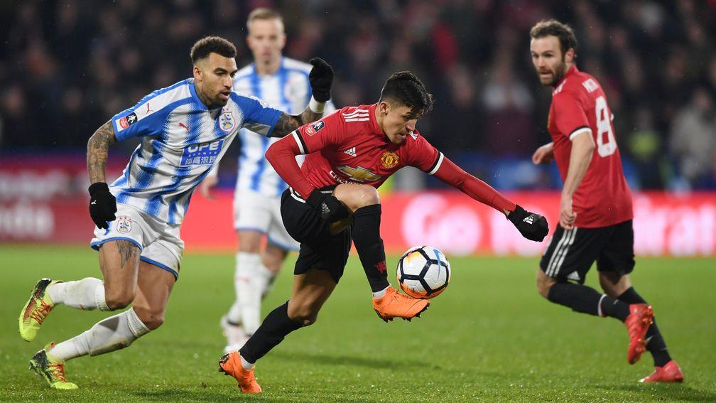 Manchester United beat Huddersfield Town 2-0 to set up an FA Cup quarter-final against Brighton & Hove Albion