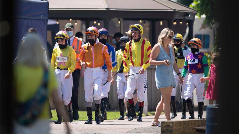 The jockeys walk to the parade ring for the opener