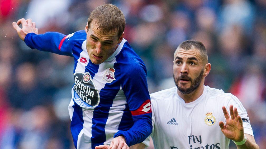 Deportivo captain Alex Bergantinos (left) vies with Karim Benzema