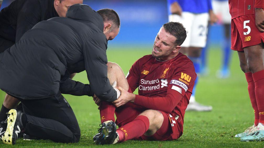 Liverpool's Jordan Henderson receives medical treatment during the Premier League match against Leicester City