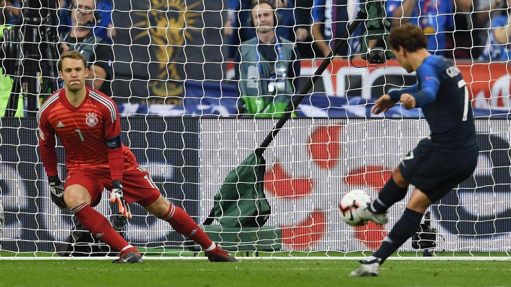 France's Antoine Griezmann sends Germany's Manuel Neuer the wrong way