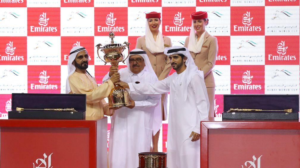 Sheikh Mohammed (left) receives the trophy after Thunder Snow's victory in the Dubai World Cup