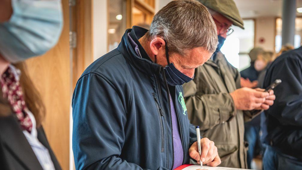 Tom Malone signs the docket on a day when he and Paul Nicholls snared three of the top five lots including the leading duo